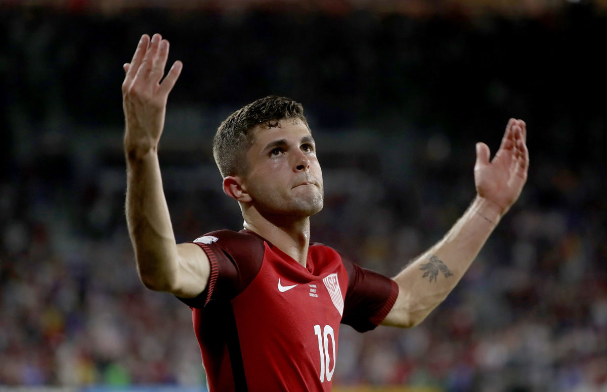 Christian Pulisic reacting to a goal during a team USA game.