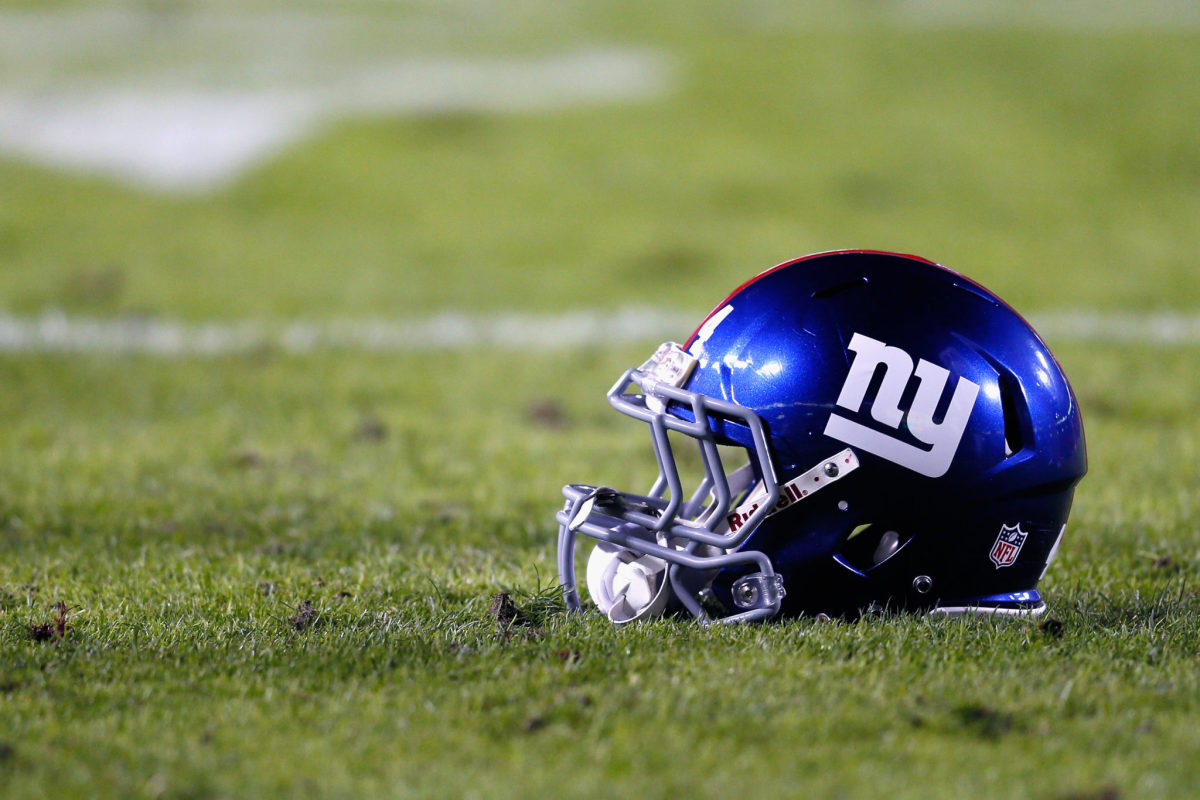 A New York Giants helmet sitting on the field.