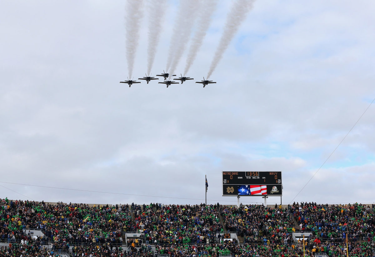 Six jets flying over Notre Dame's football stadium.