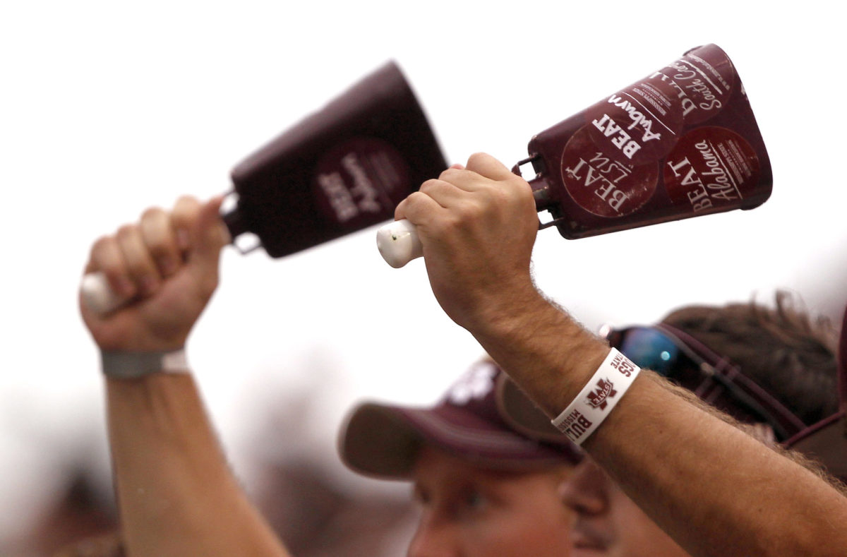 A closeup of Mississippi State fans ringing cow bells.