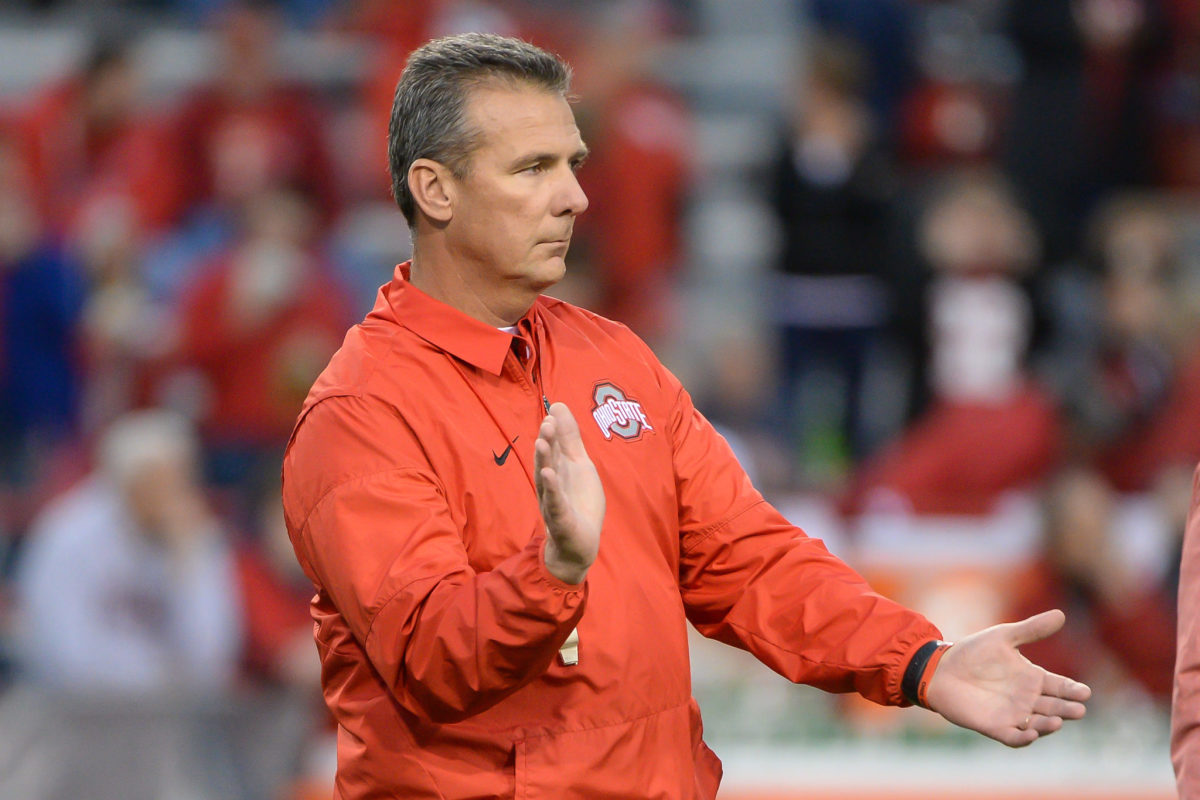 A closeup of Urban Meyer clapping before an Ohio State football game.
