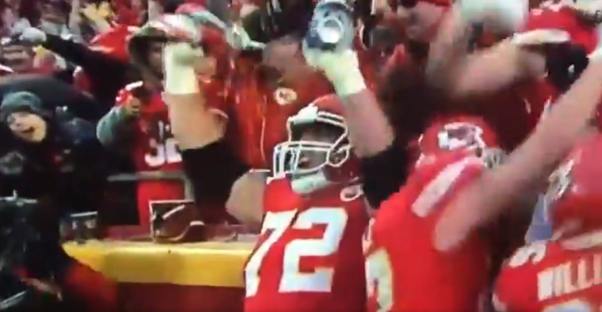 Kansas City Chiefs star Eric Fisher celebrates with fans' beers.