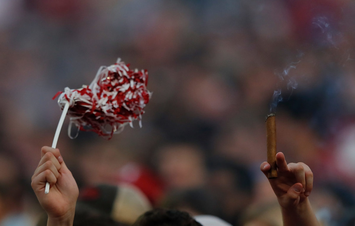 Alabama football fan holds up cigar during game vs. Tennessee.