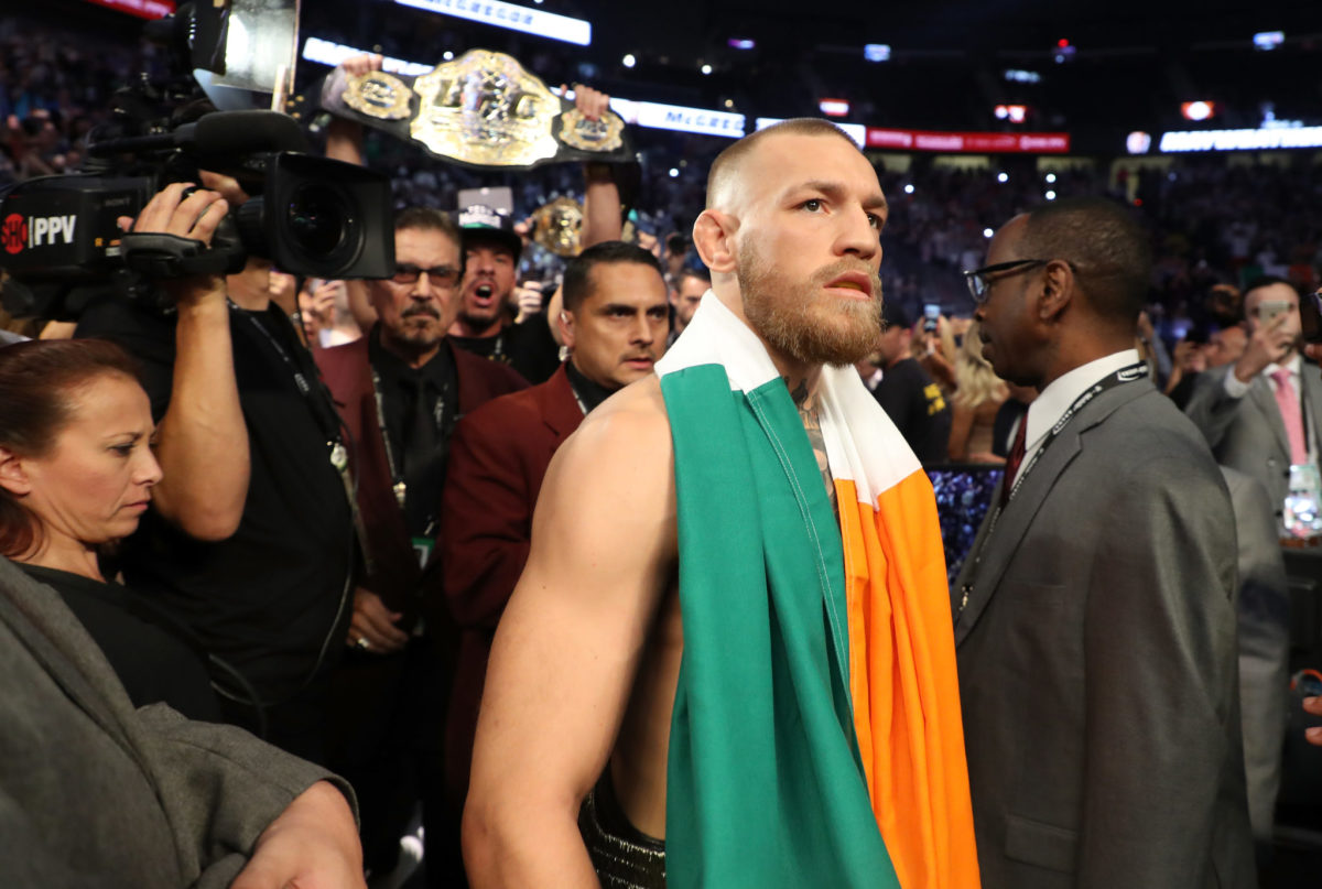 Conor McGregor with an Irish flag draped over his shoulders.