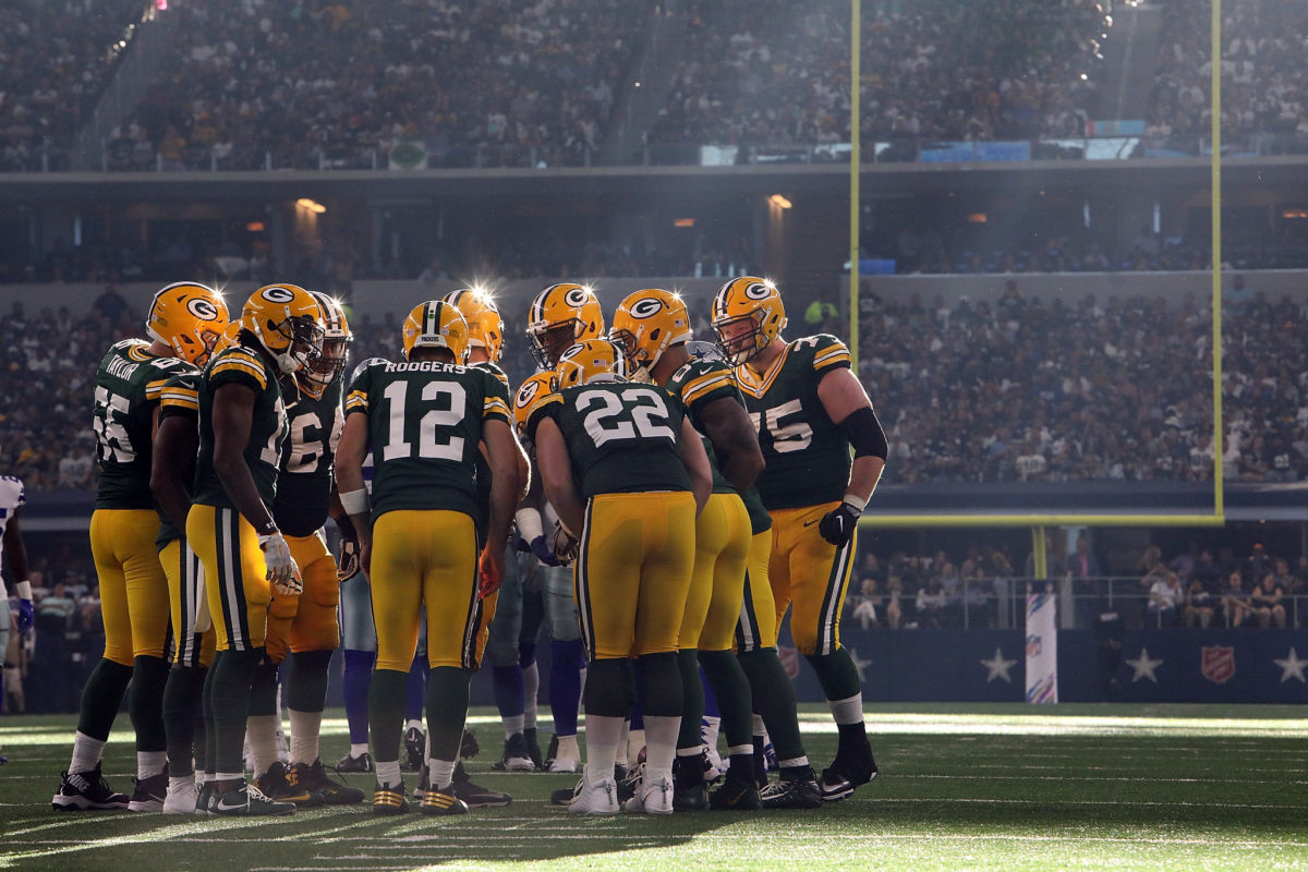 Aaron Rodgers in the huddle with his teammates.