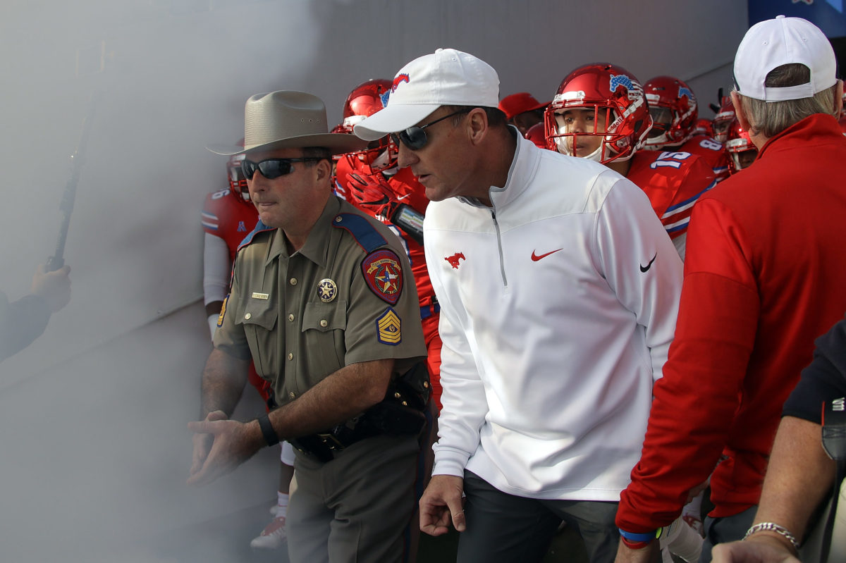 Chad Morris leading the SMU Mustangs onto the field.