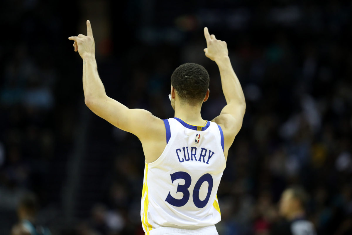 Stephen Curry pointing to the crowd during a game.