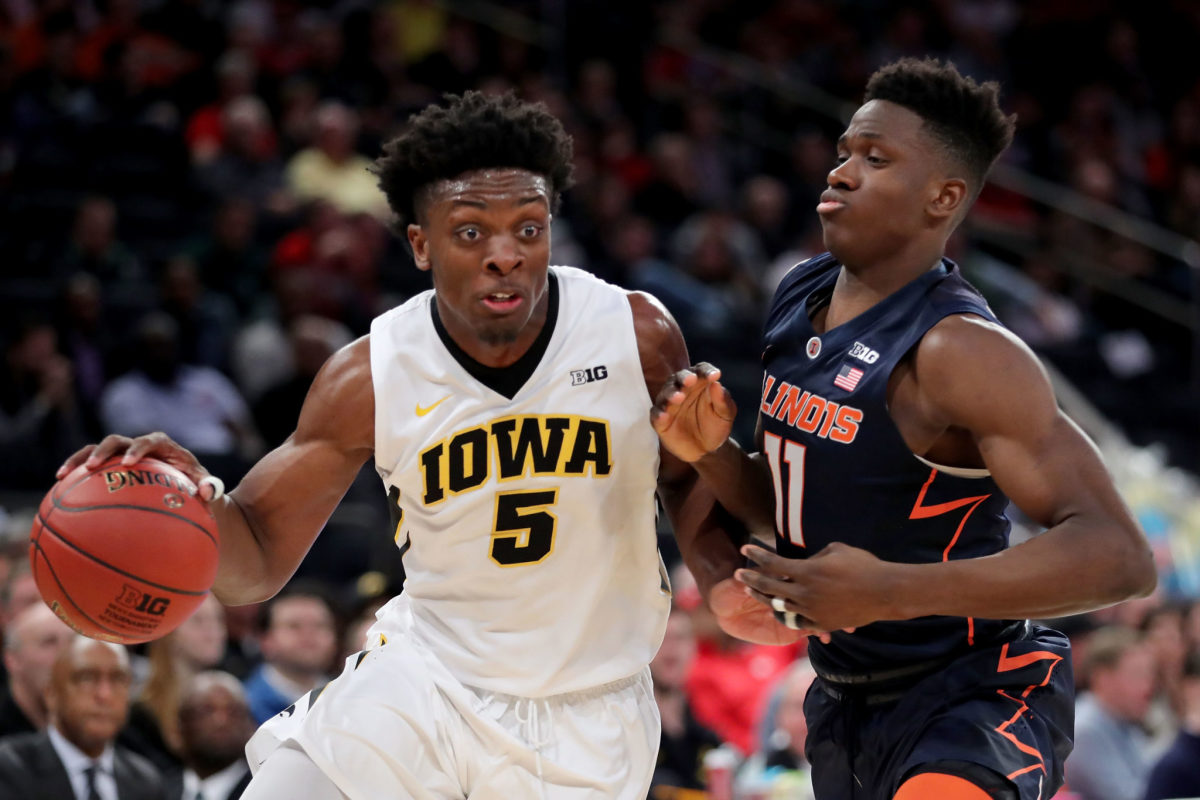 Iowa's Tyler Cook drives against an Illinois defender.