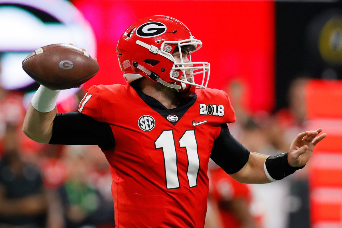 Jake Fromm throwing a pass in his red Georgia Bulldog's uniform.