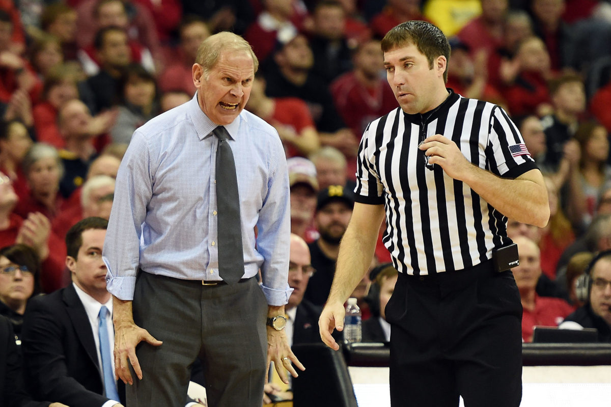 Head coach John Beilein of the Michigan Wolverines reacts to an official's call during a game against the Wisconsin Badgers at the Kohl Center.