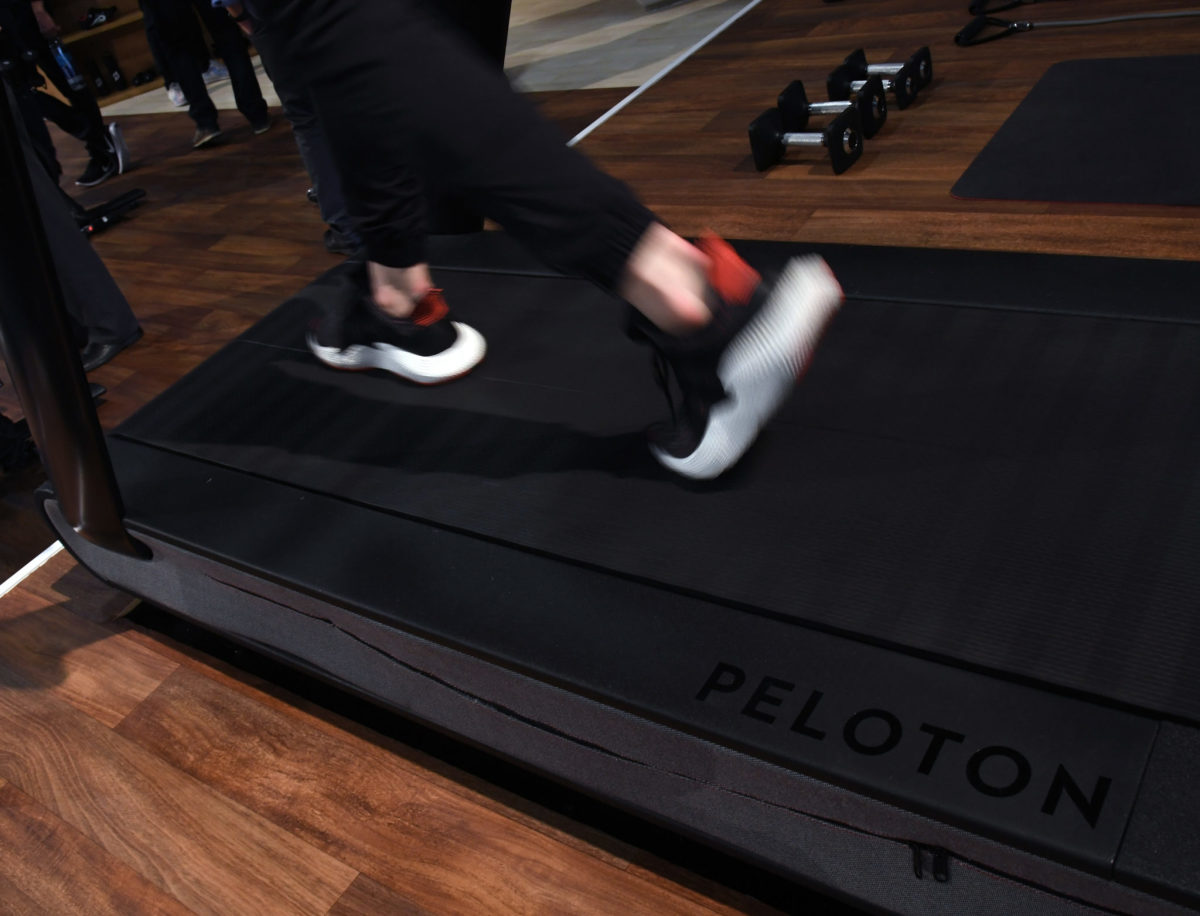 A person uses the Peloton Tread treadmill.