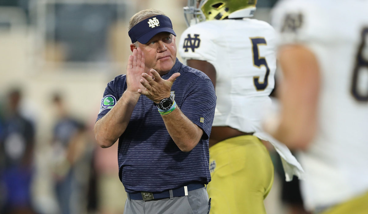 Brian Kelly clapping on the Notre Dame sideline.