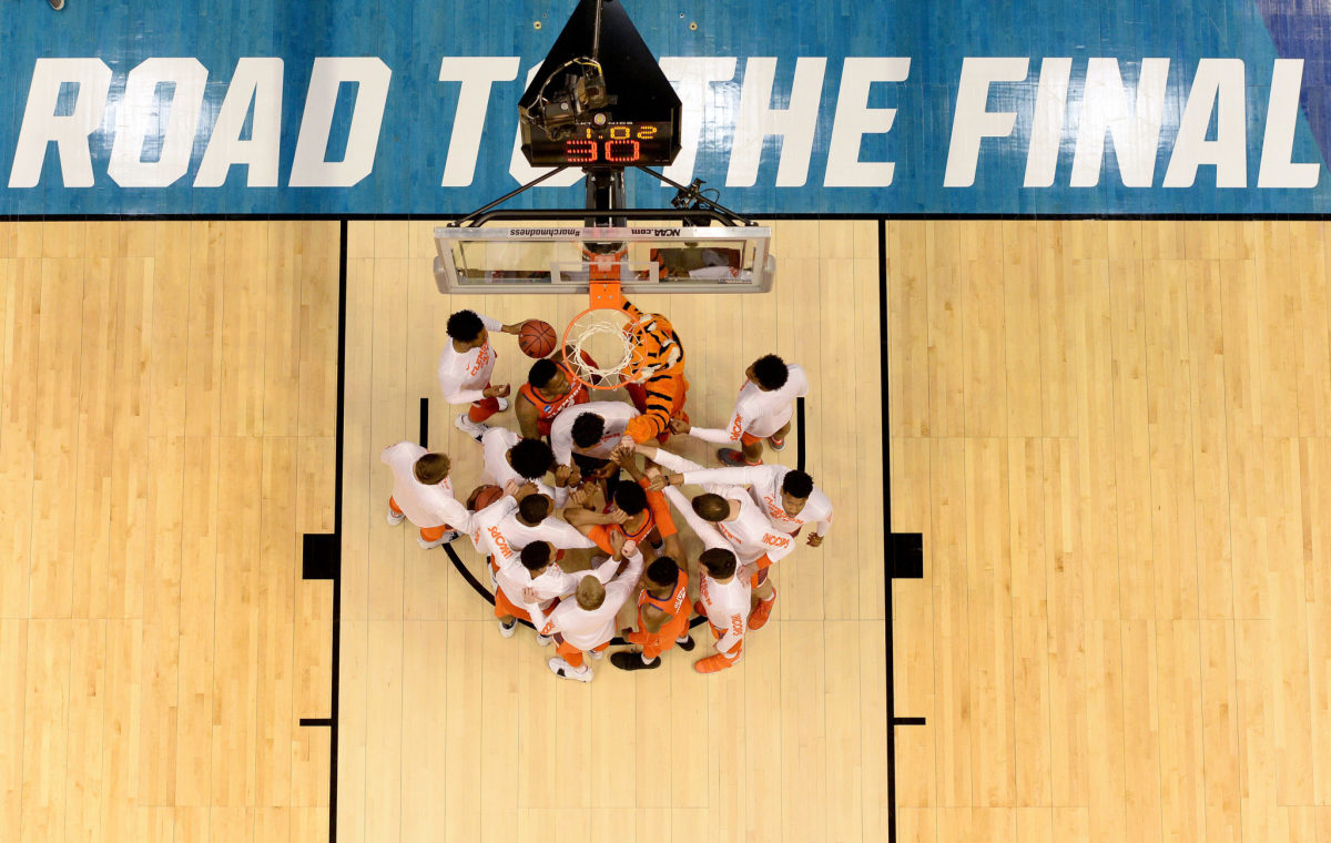 Clemson's basketballl team standing under the hoop.