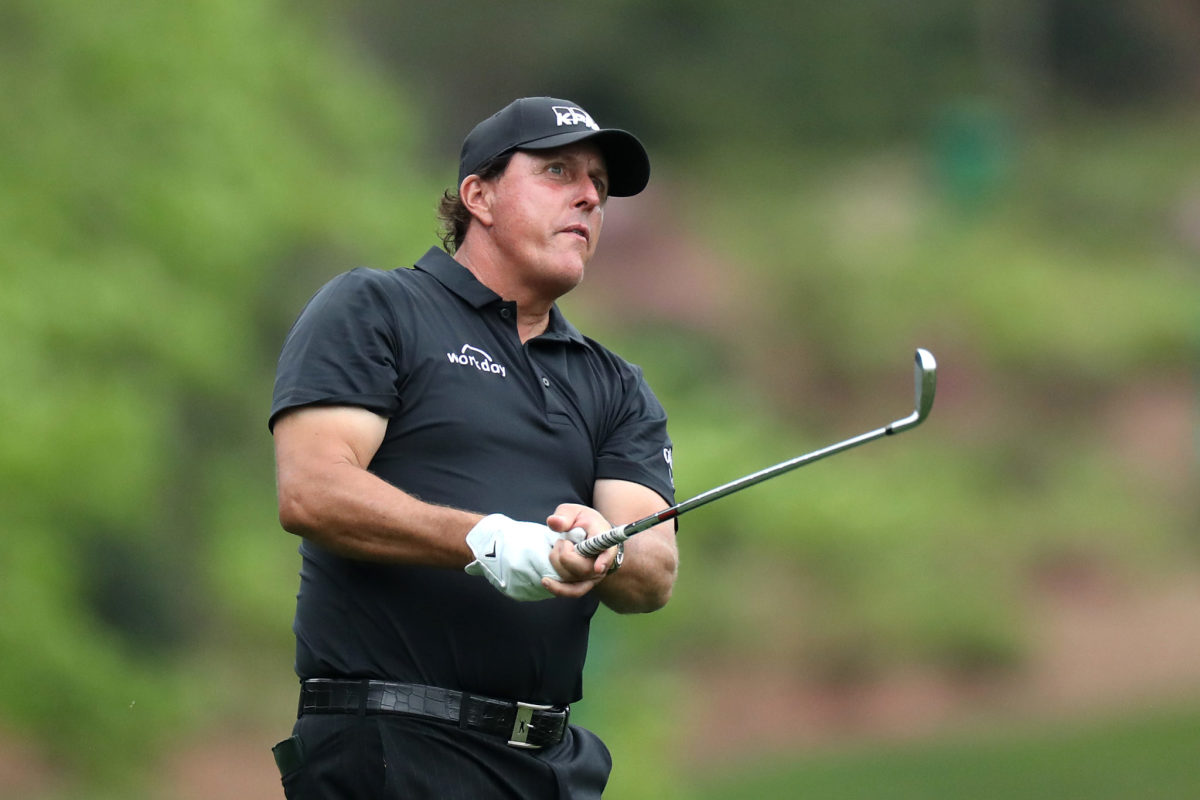 A closeup of Phil Mickelson after hitting a golf ball.