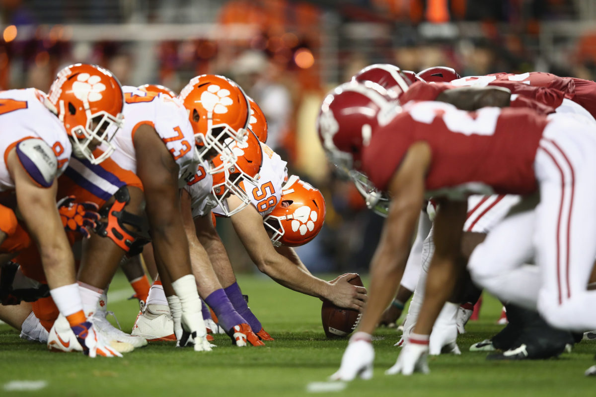 Alabama and Clemson players lining up for a snap.