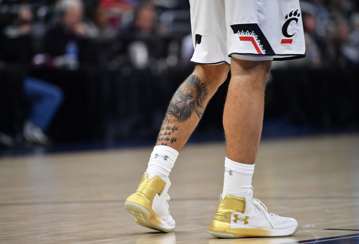 A closeup of a Cincinnati basketball player's calf tattoo.