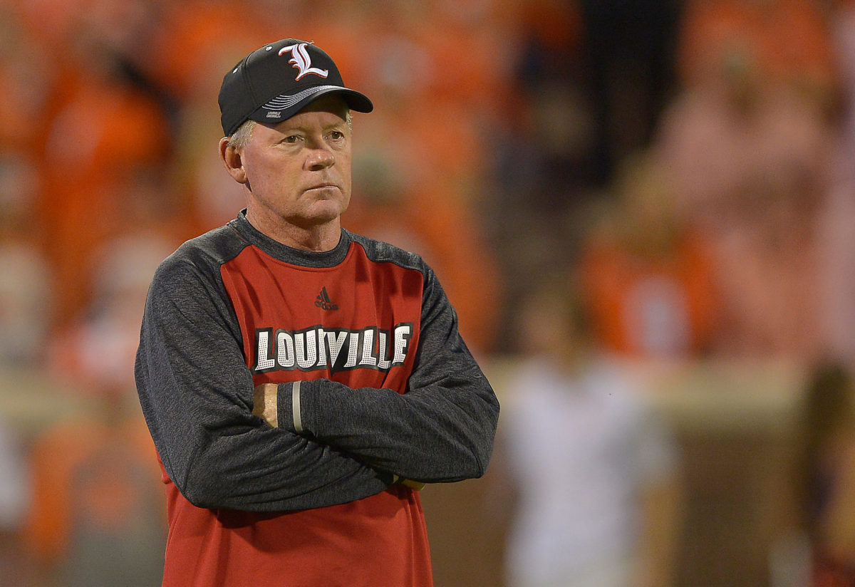Bobby Petrino with his arms folded ahead of a Louisville game.