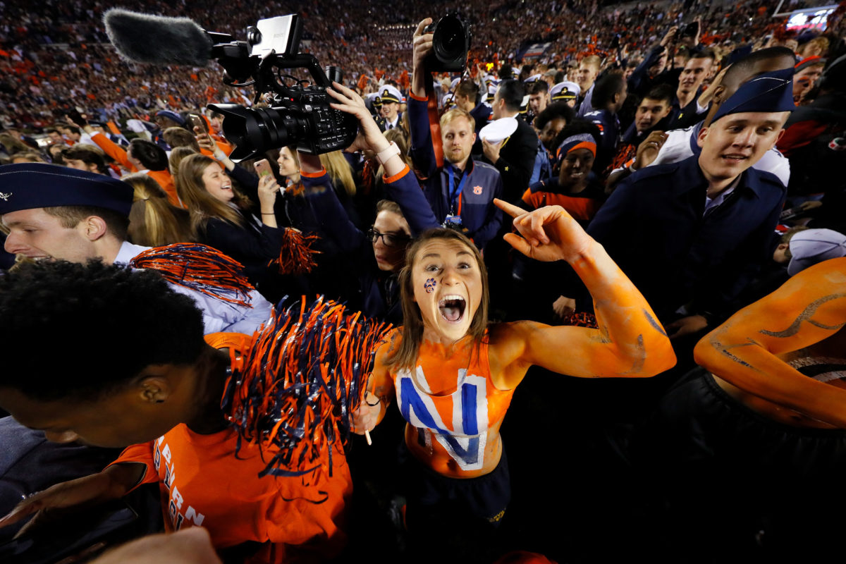 Auburn fans celebrating on the field after they beat Alabama.