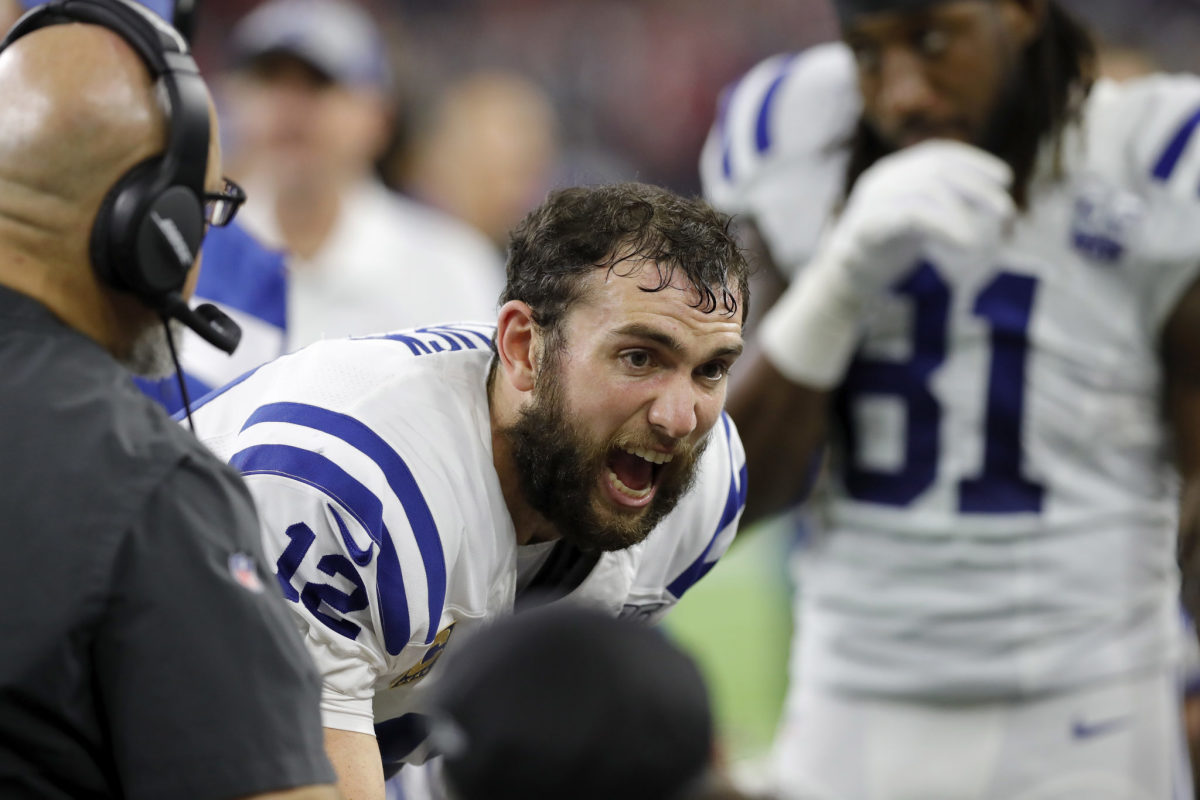 Andrew Luck talking to his teammates on the sideline.