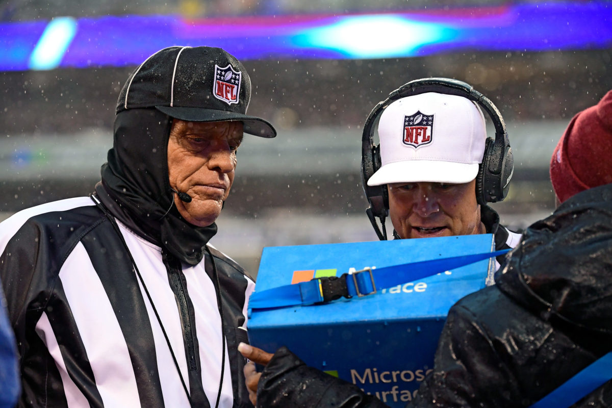 nfl referees reviewing a play during a game