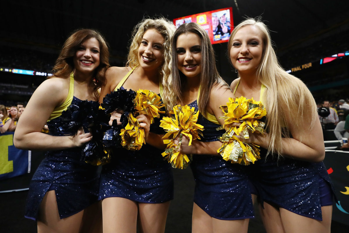 The Michigan Wolverines cheerleaders pose before the 2018 NCAA Men's Final Four National Championship game against the Villanova Wildcats.