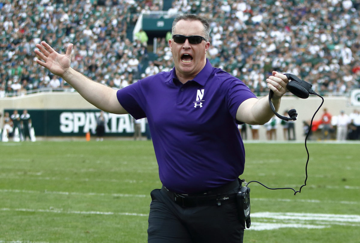 A closeup of Pat Fitzgerald yelling during a Northwestern football game.