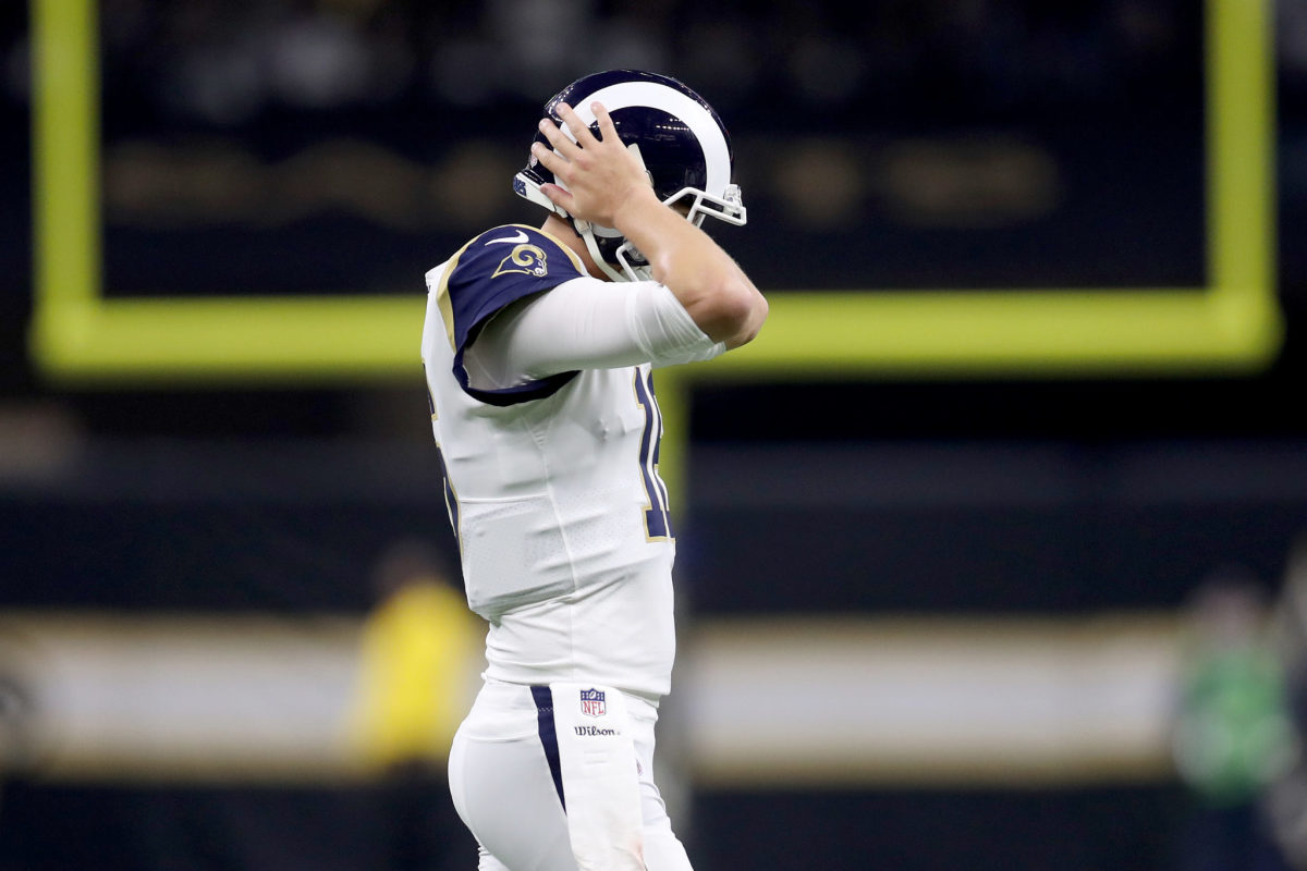 jared goff having problems with his helmet against the saints