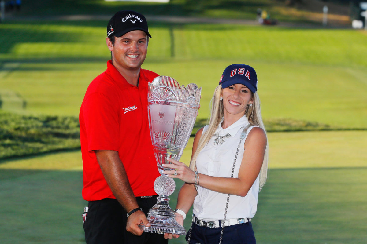 Patrick Reed posing with his wife.