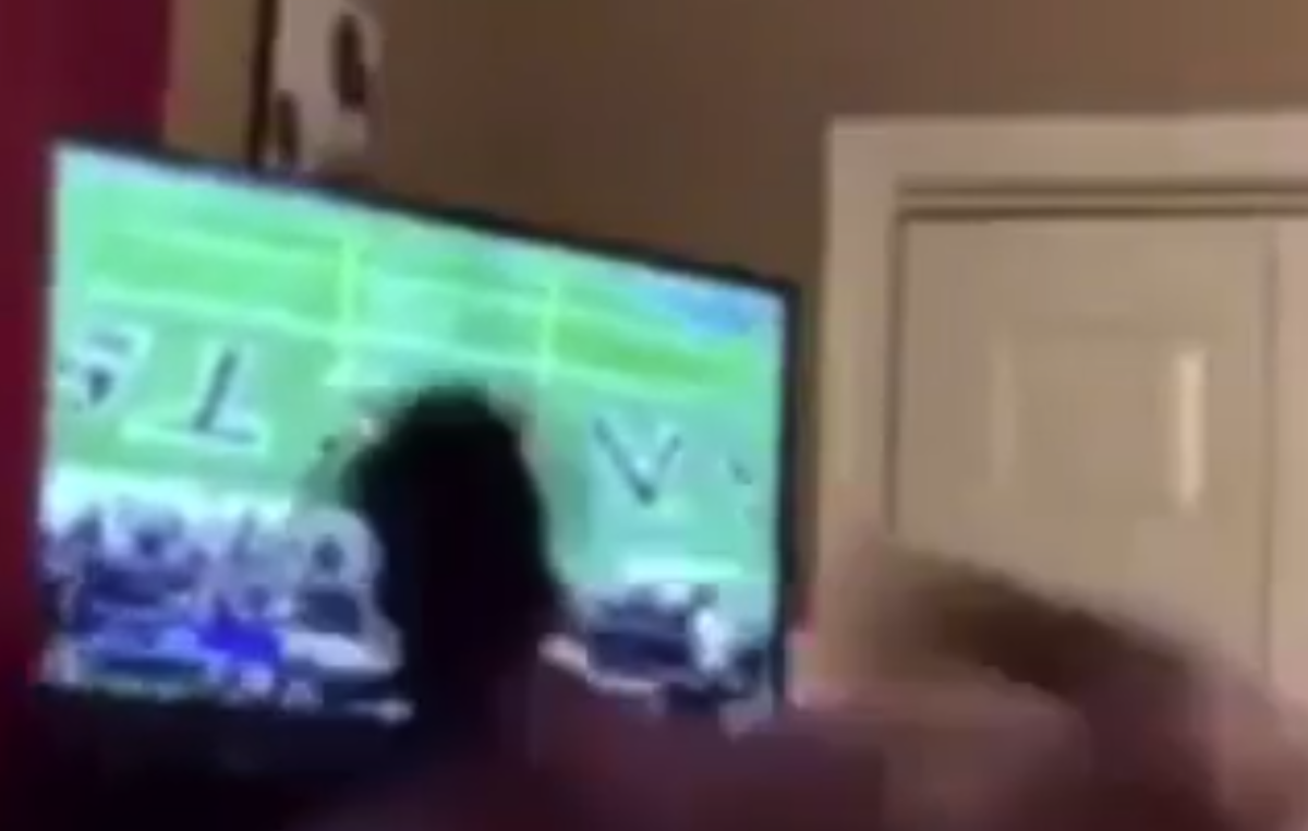 A Saints fan breaks his television after the team's loss.
