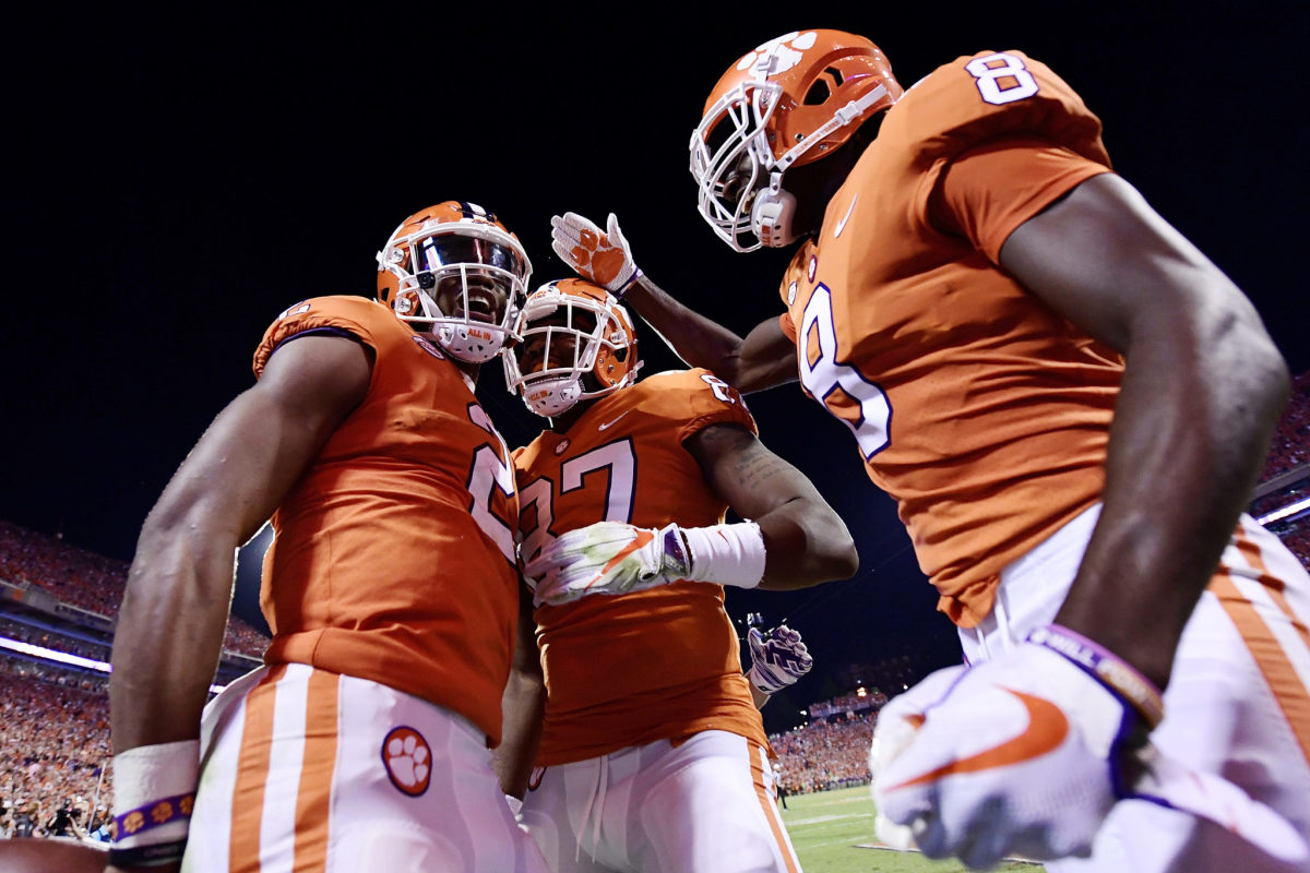 Clemson Quarterback Kelly Bryant #2, wide receiver Deon Cain #8, and tight end D.J. Greenlee #87 of the Clemson Tigers celebrate following Bryant's touchdown.