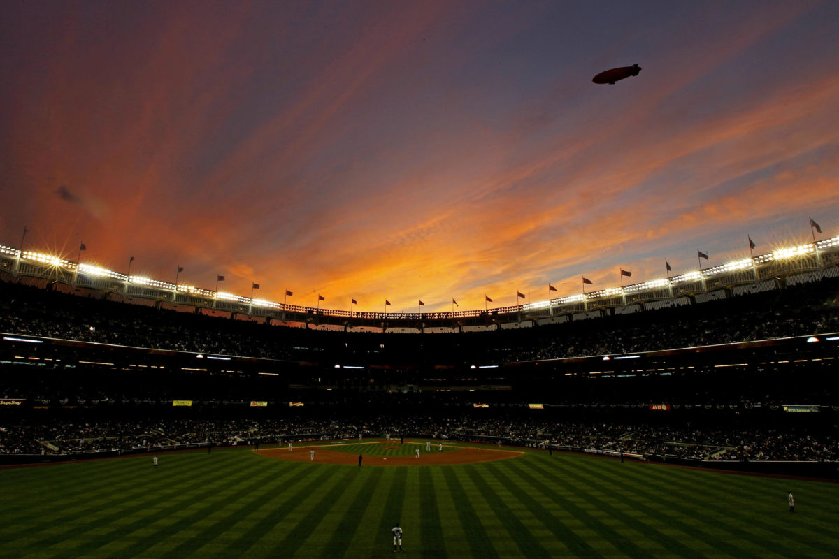 A view of the field in Yankee stadium from the bleachers of an MLB game.