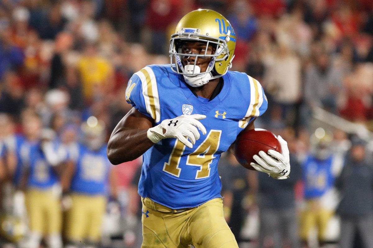 UCLA wide receiver Theo Howard runs with the ball.