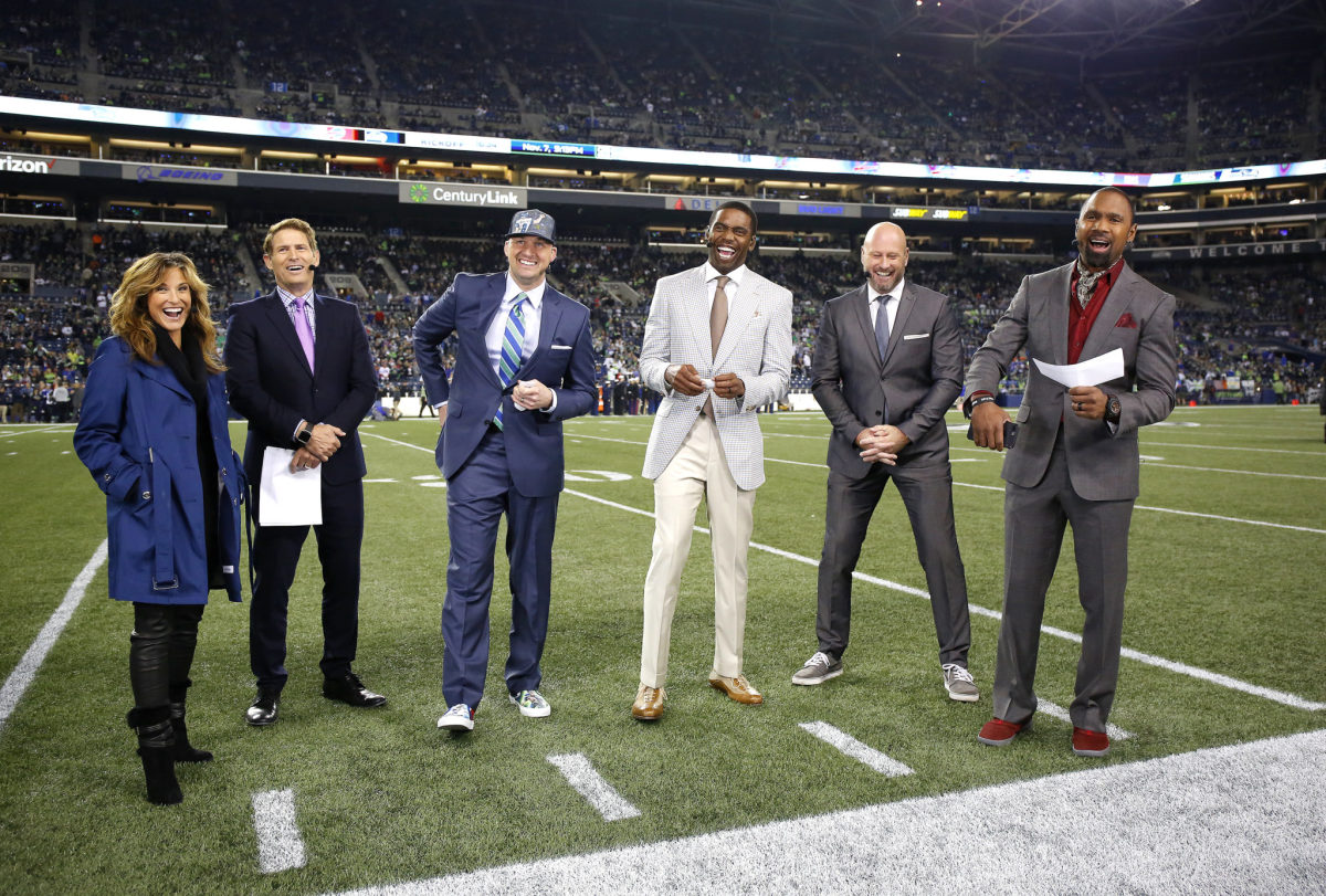 The Monday Night football crew of ESPN NFL analysts on the field.