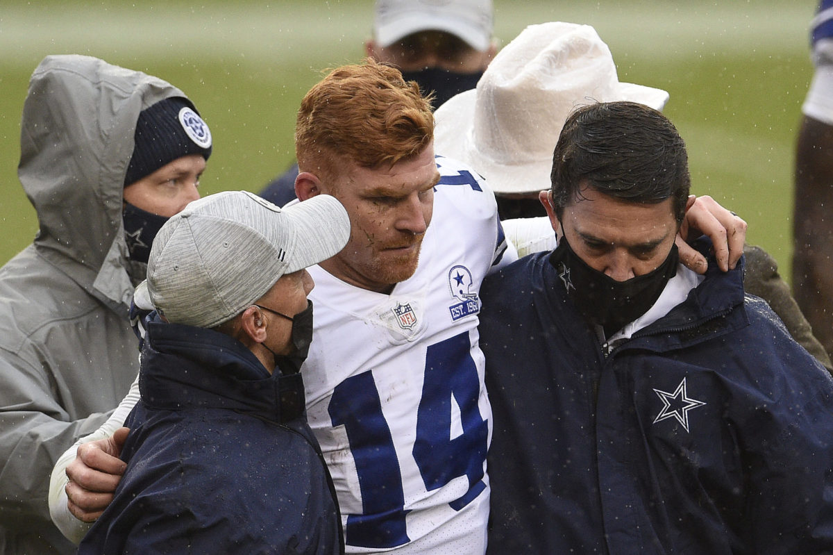 Dallas Cowboys quarterback Andy Dalton gets helped off the field.