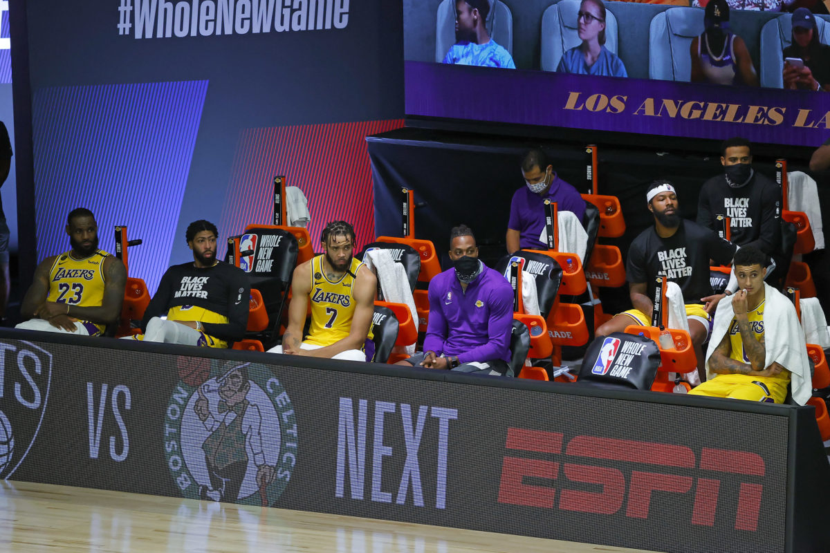 Los Angeles Lakers sit on the bench.