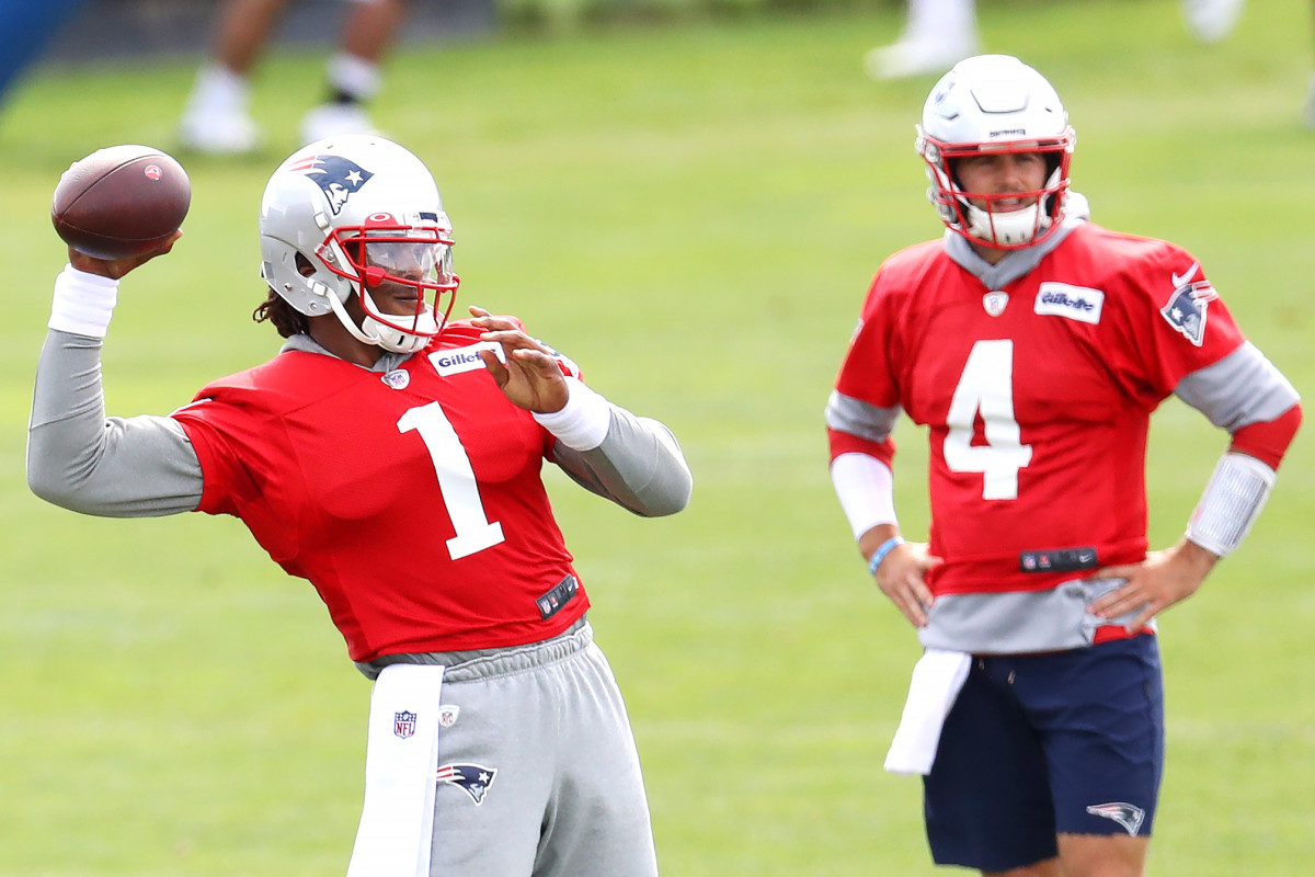 Cam Newton and Jarrett Stidham stand together at New England Patriots practice.