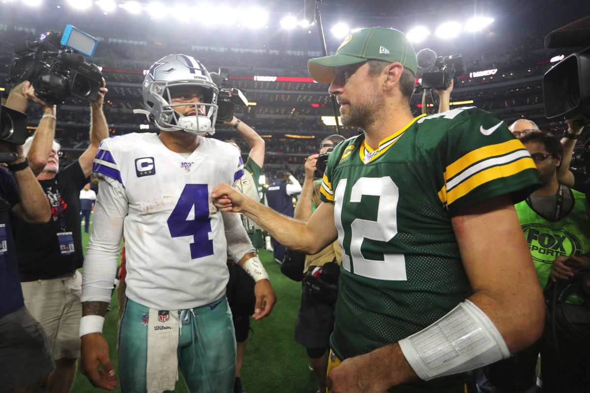 Aaron Rodgers and Dak Prescott at midfield after a Packers-Cowboys game.