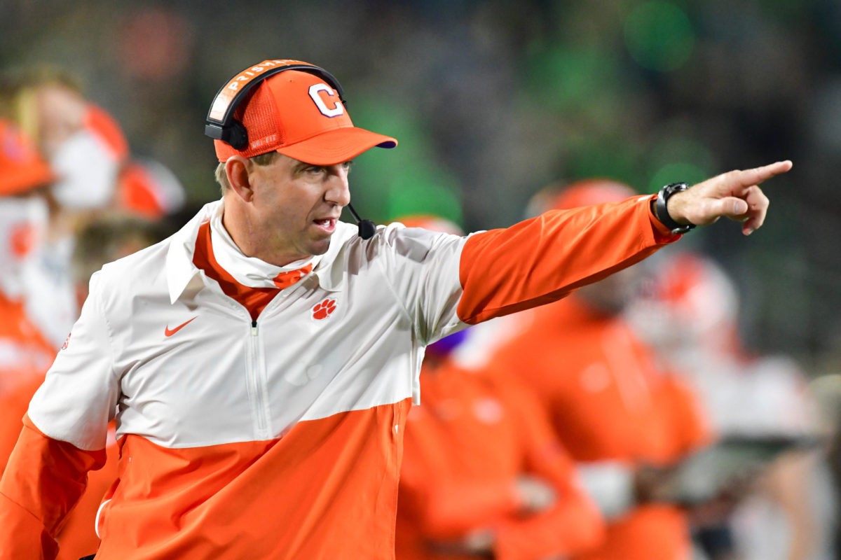 Head coach Dabo Swinney of the Clemson Tigers signals to his players