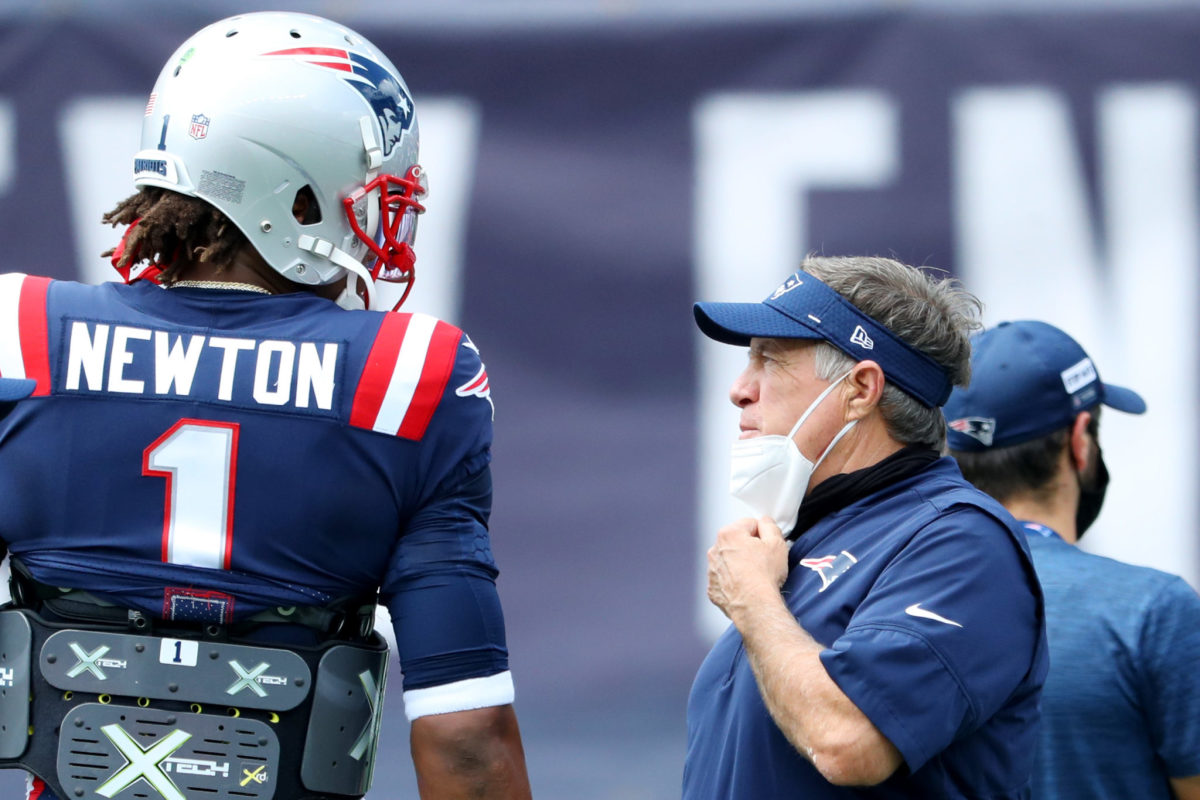 Cam Newton and Bill Belichick speak on the sideline during a New England Patriots game.
