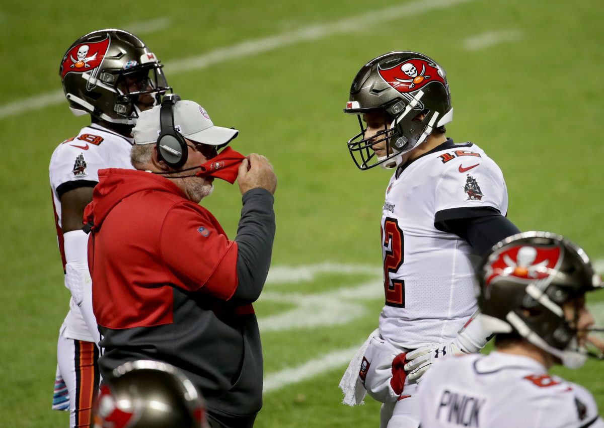 Head coach Bruce Arians of the Tampa Bay Buccaneers meets with Tom Brady #12