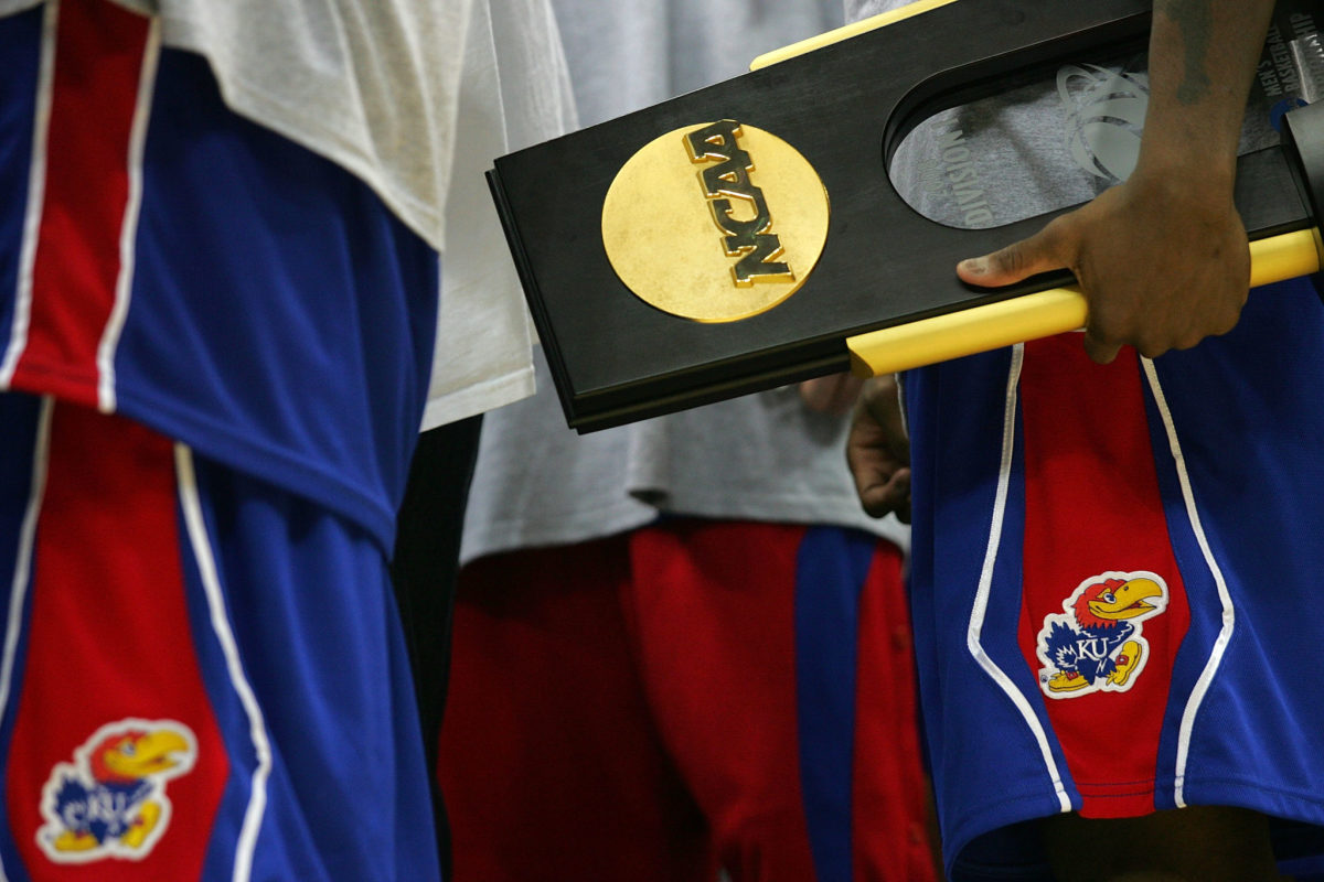 A Kansas player holding up the National Championship trophy.