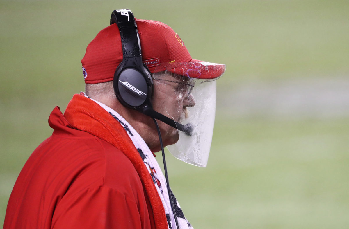 Andy Reid stands on the sideline with a face shield.
