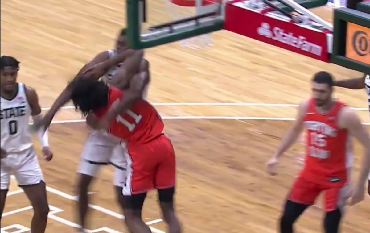 Illinois basketball star Ayo Dosmonsu is fouled by Michigan State's Mady Sissoko.