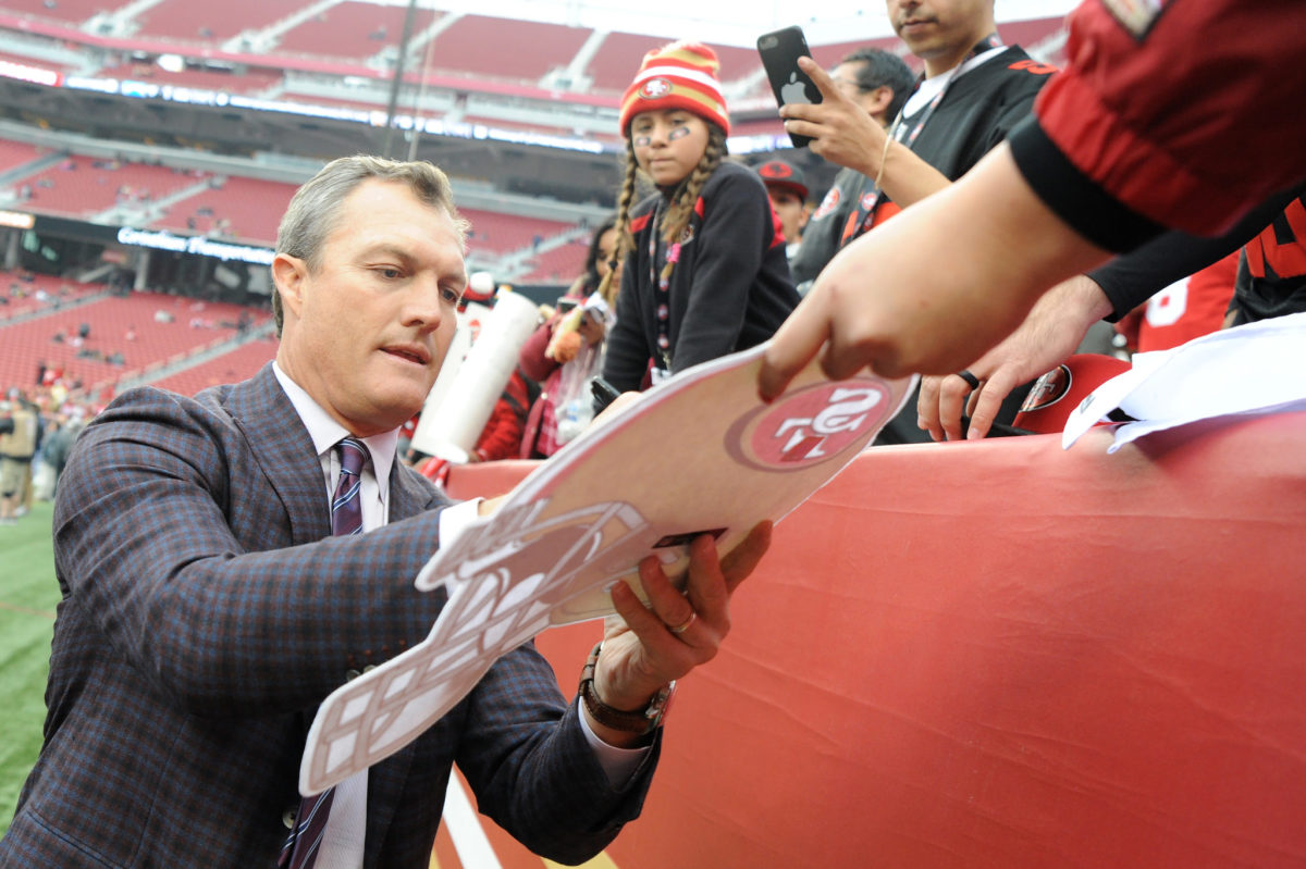 49ers GM John Lynch signing autographs.
