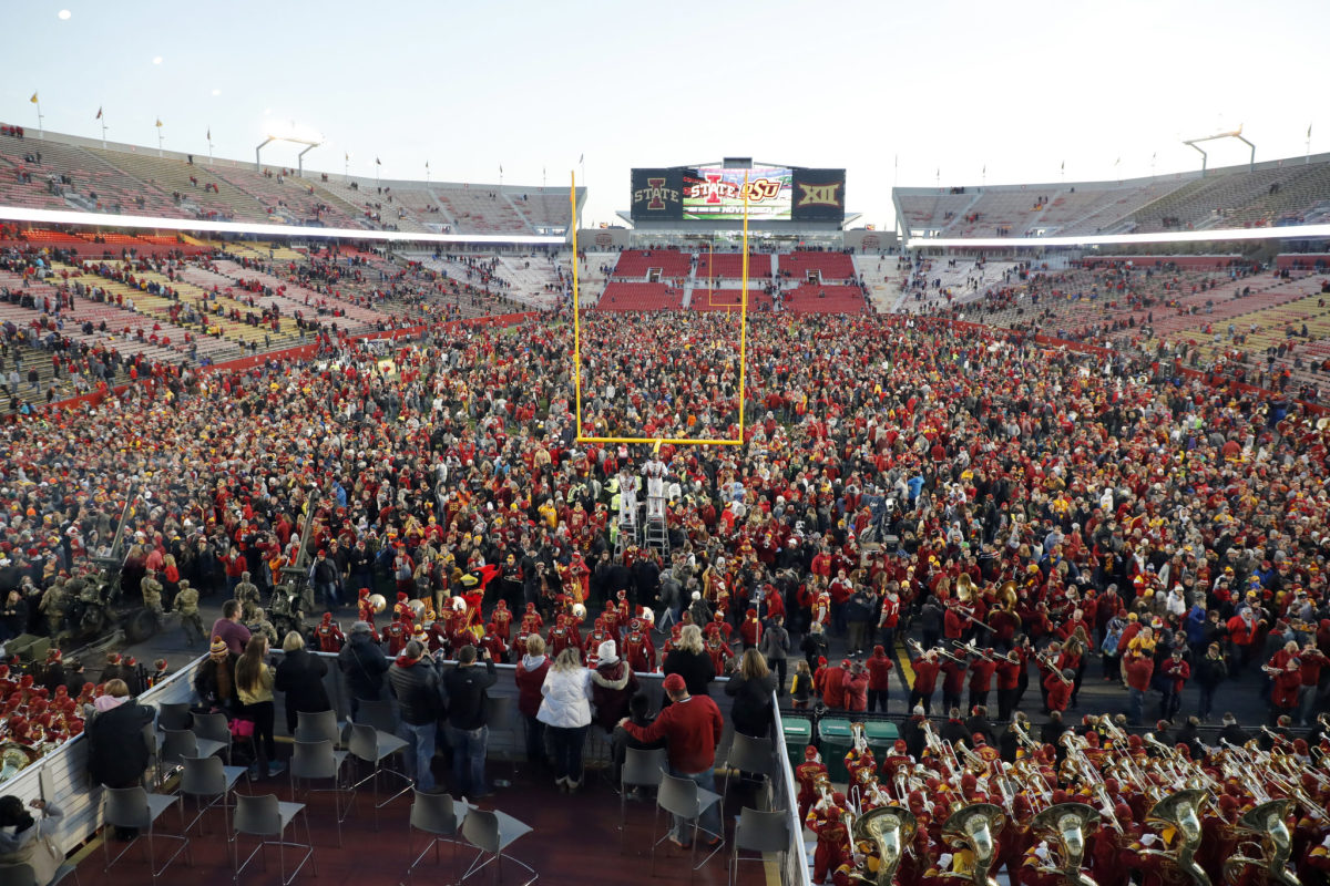 Iowa State fans storm the field after win.