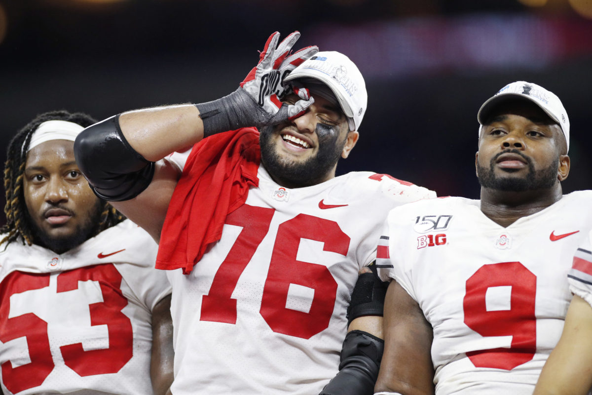 Davon Hamilton #53, Branden Bowen #76 and Jashon Cornell #9 of the Ohio State Buckeyes celebrate after the win against the Wisconsin Badgers in the Big Ten Football Championship