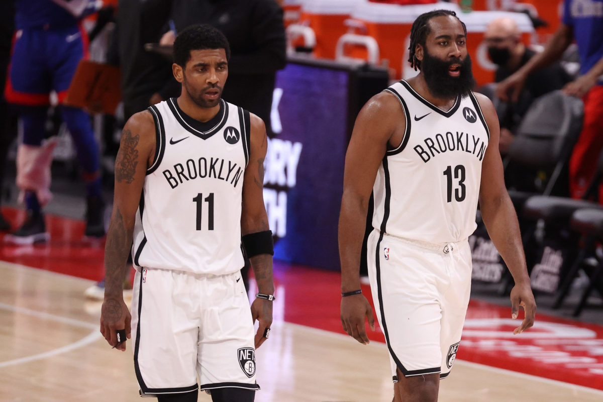 Kyrie Irving #11 and James Harden #13 of the Brooklyn Nets walking down the court