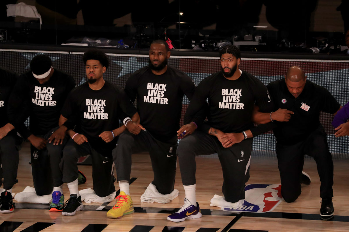 LeBron James and his NBA teammates take a knee during the national anthem.