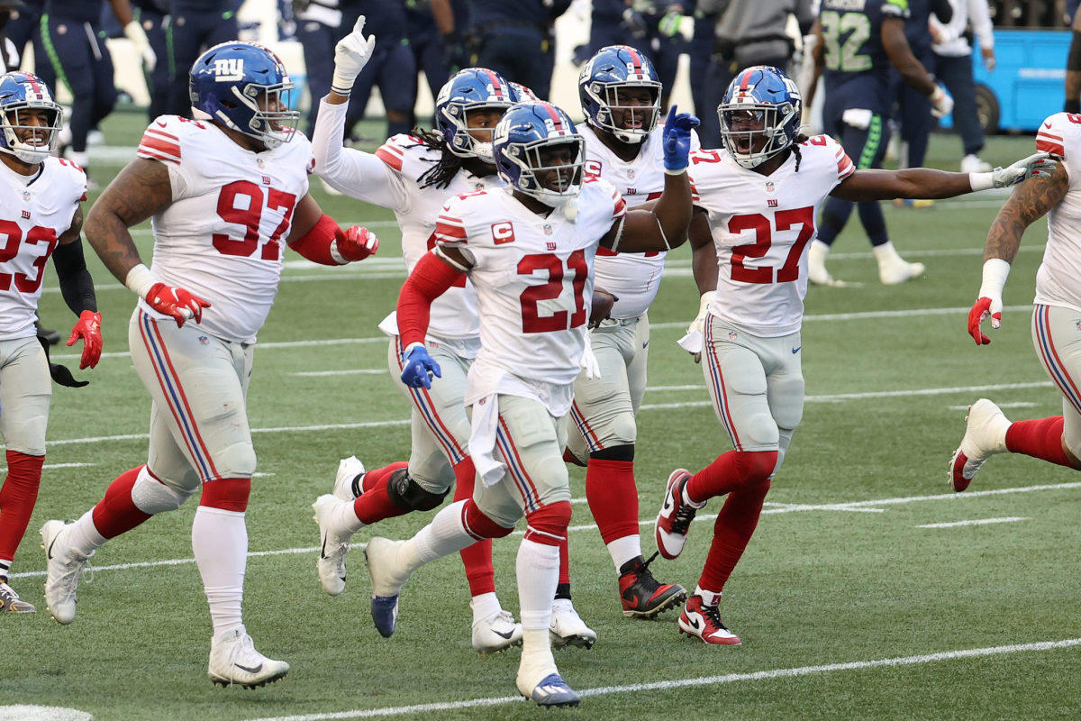 Giants players celebrate on the field in Seattle.