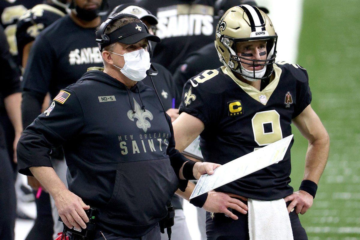 Sean Payton and Drew Brees stand next to each other on the New Orleans Saints sideline.